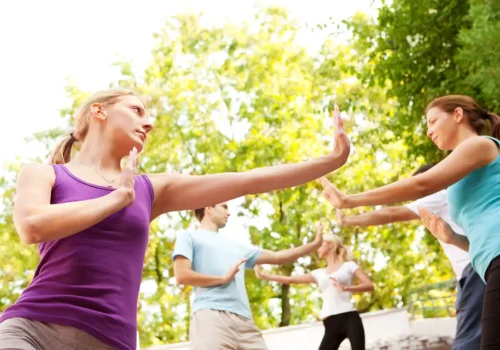 yoga y taichí. Gente practicando taichí en el parque